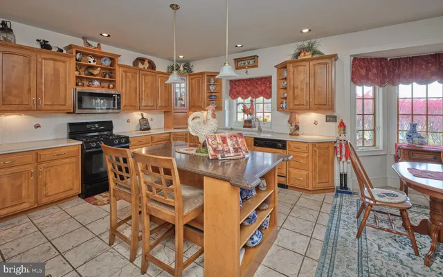 a kitchen with stainless steel appliances granite countertop a sink and cabinets