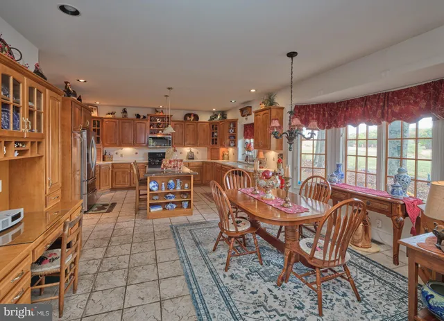 a dining room with furniture a chandelier and wooden floor