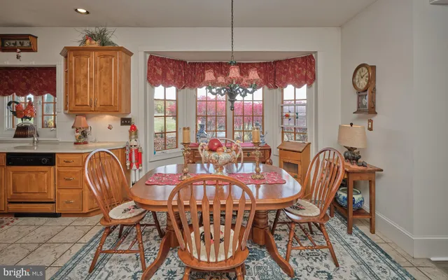 a dining room with furniture a chandelier and window