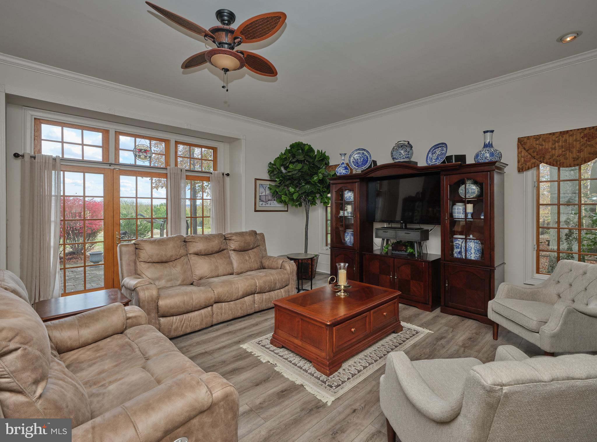 137 Wells Road Doylestown, PA 18901 - Photo 21 of 54 a living room with furniture a chandelier and a floor to ceiling window