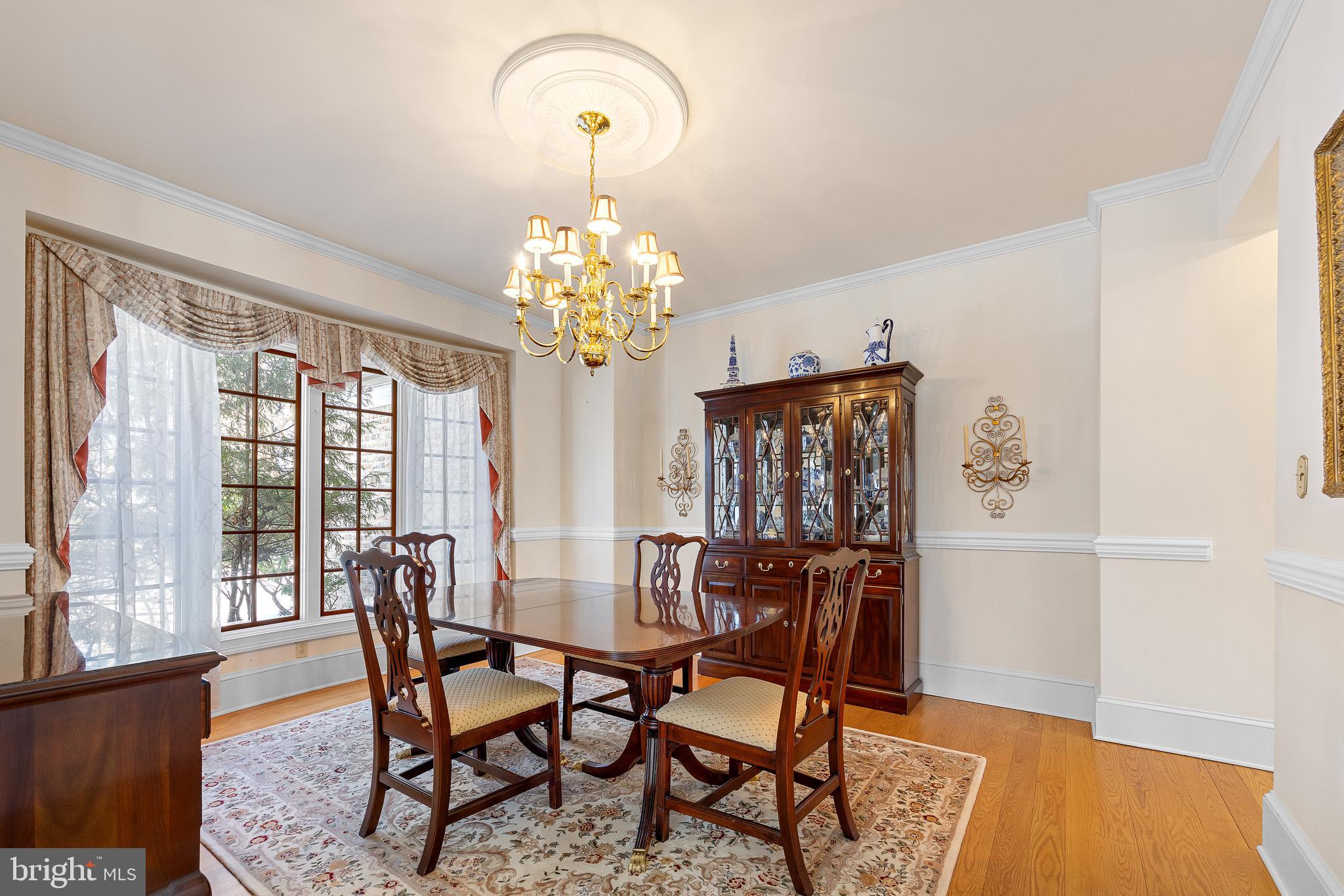 137 Wells Road Doylestown, PA 18901 - Photo 26 of 102 a view of a dining room with furniture a chandelier and wooden floor