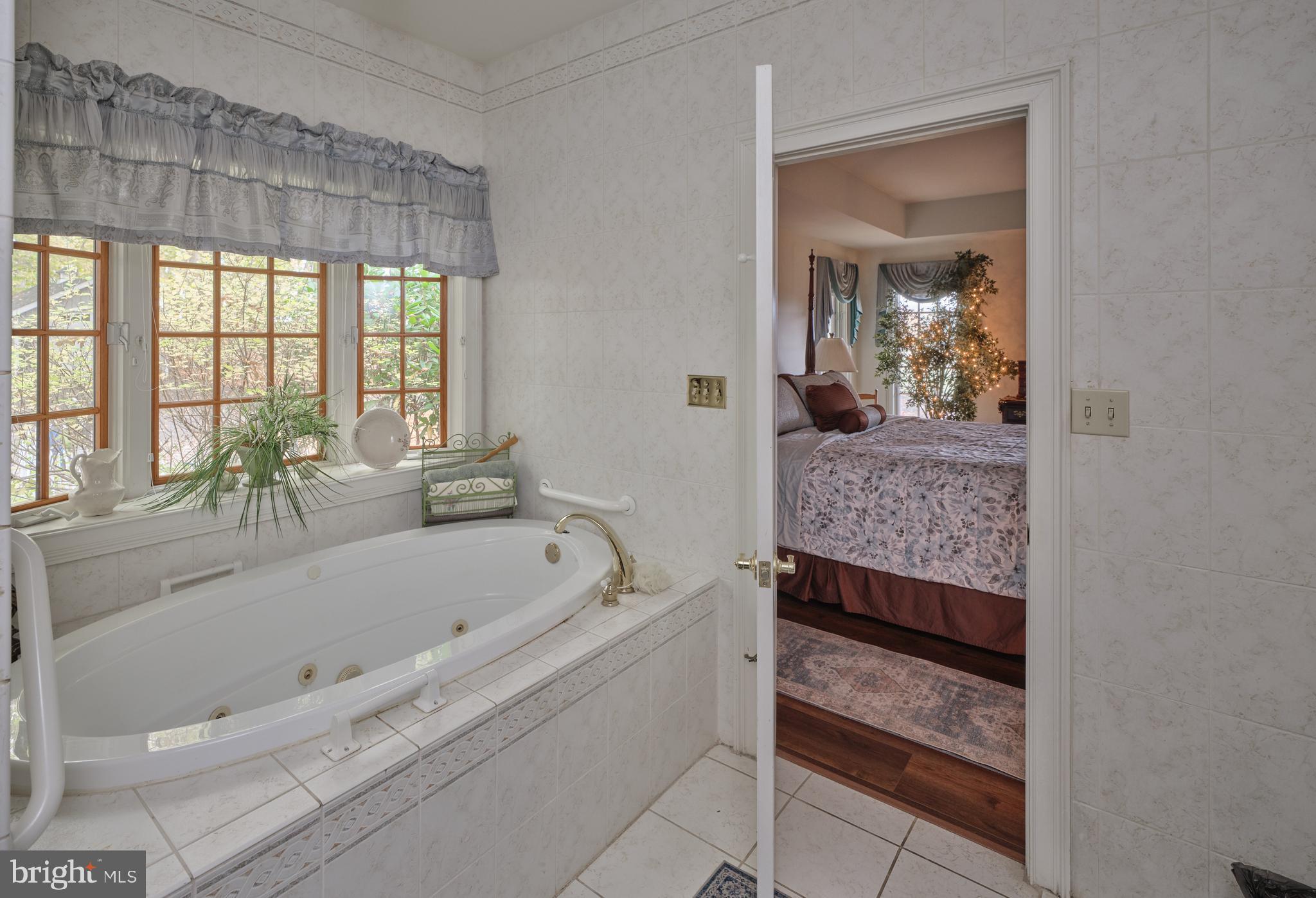 137 Wells Road Doylestown, PA 18901 - Photo 27 of 54 a bathroom with a granite countertop tub sink and mirror