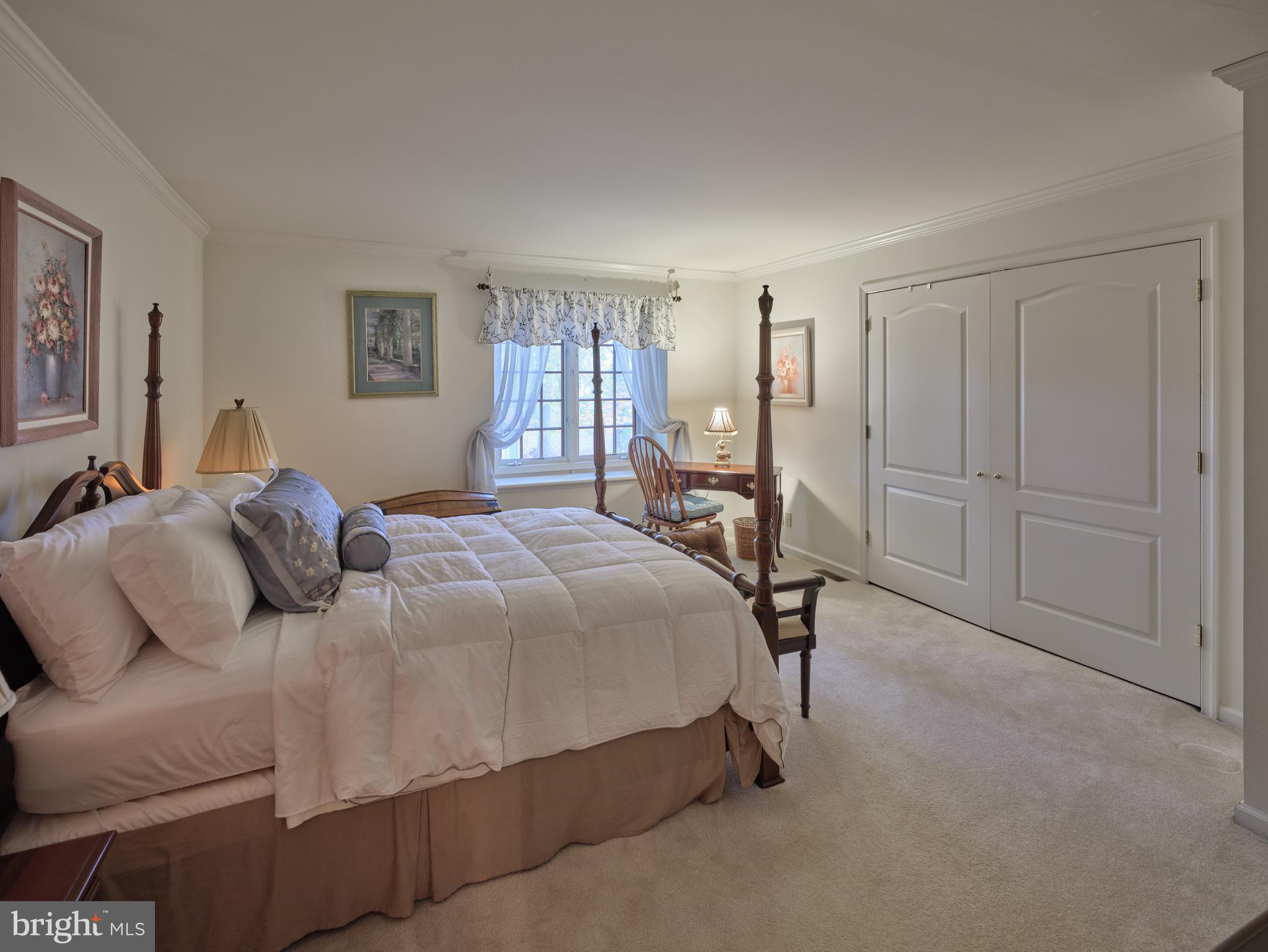 137 Wells Road Doylestown, PA 18901 - Photo 28 of 54 a bedroom with a bed a table and painting