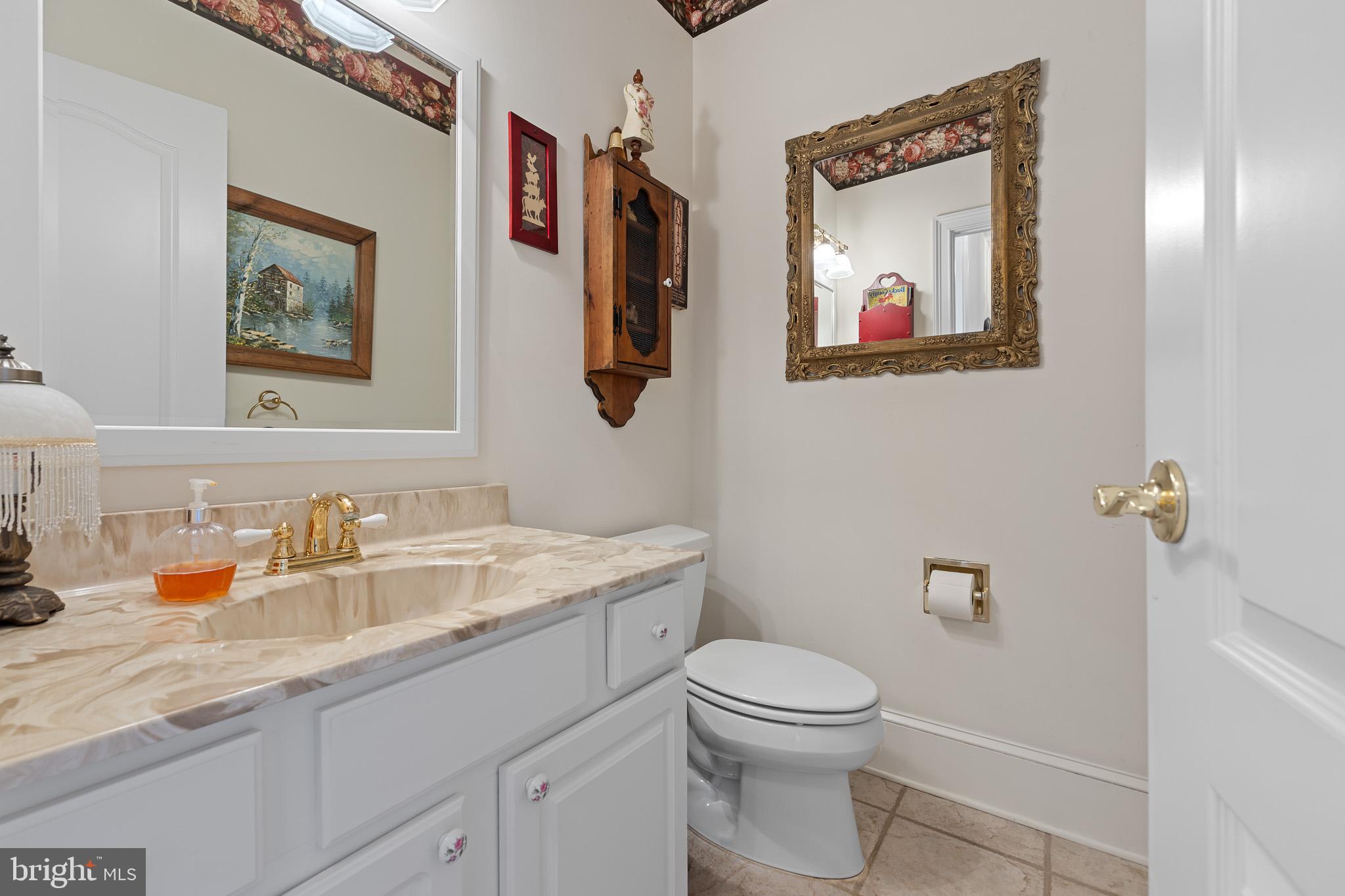 137 Wells Road Doylestown, PA 18901 - Photo 44 of 102 a bathroom with a toilet a sink and mirror