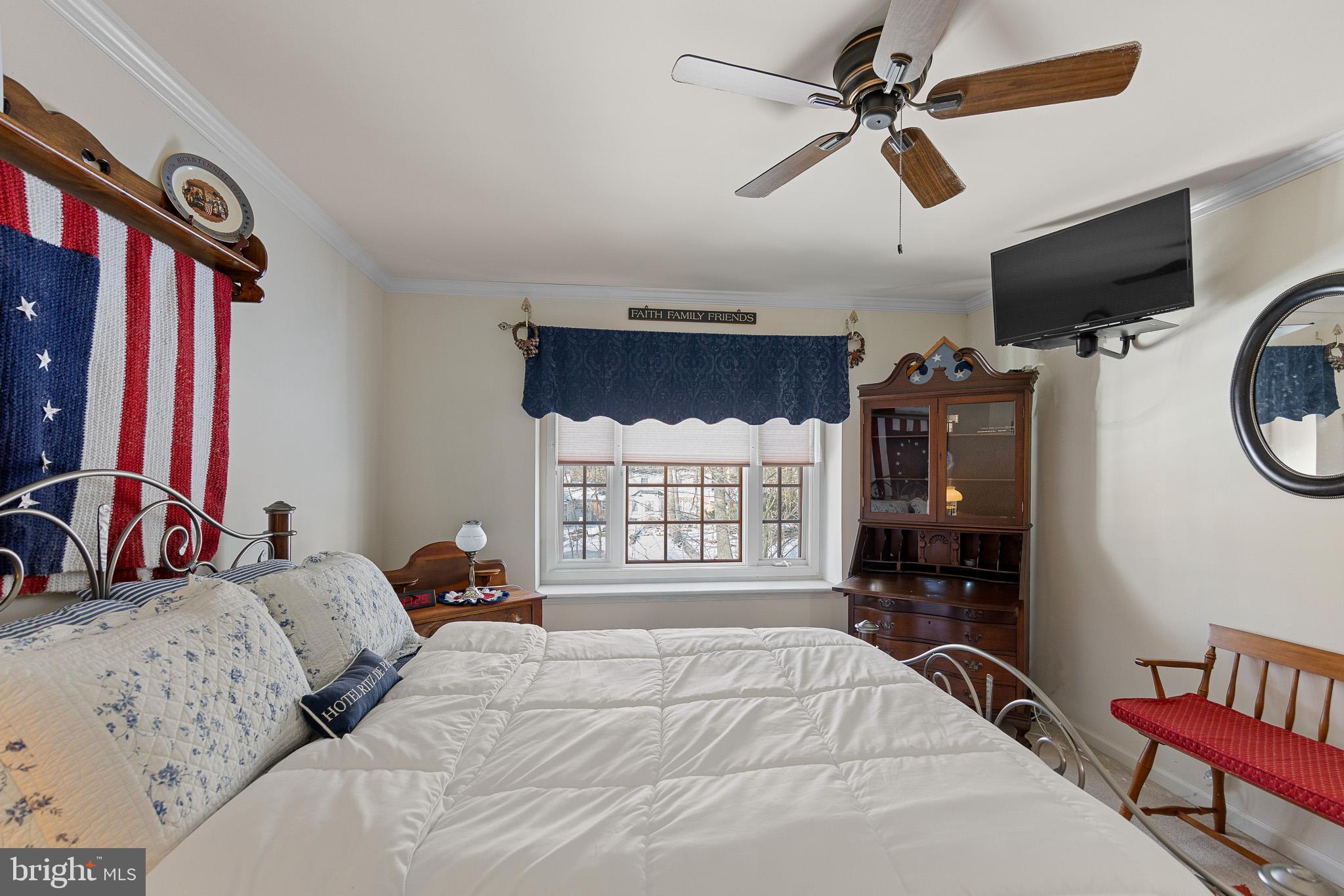 137 Wells Road Doylestown, PA 18901 - Photo 61 of 102 a bedroom with a bed a dresser and flat screen tv
