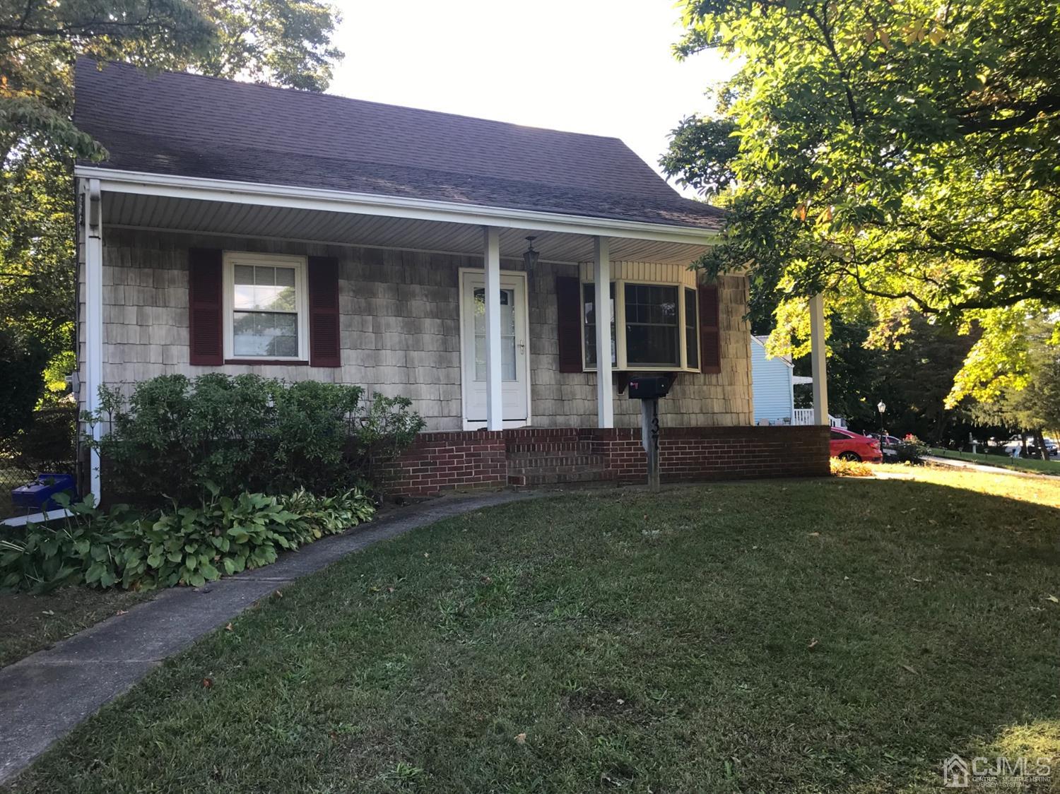 137 Milltown Road East Brunswick, NJ 08816 - Photo 1 of 22 a view of a brick house with a yard