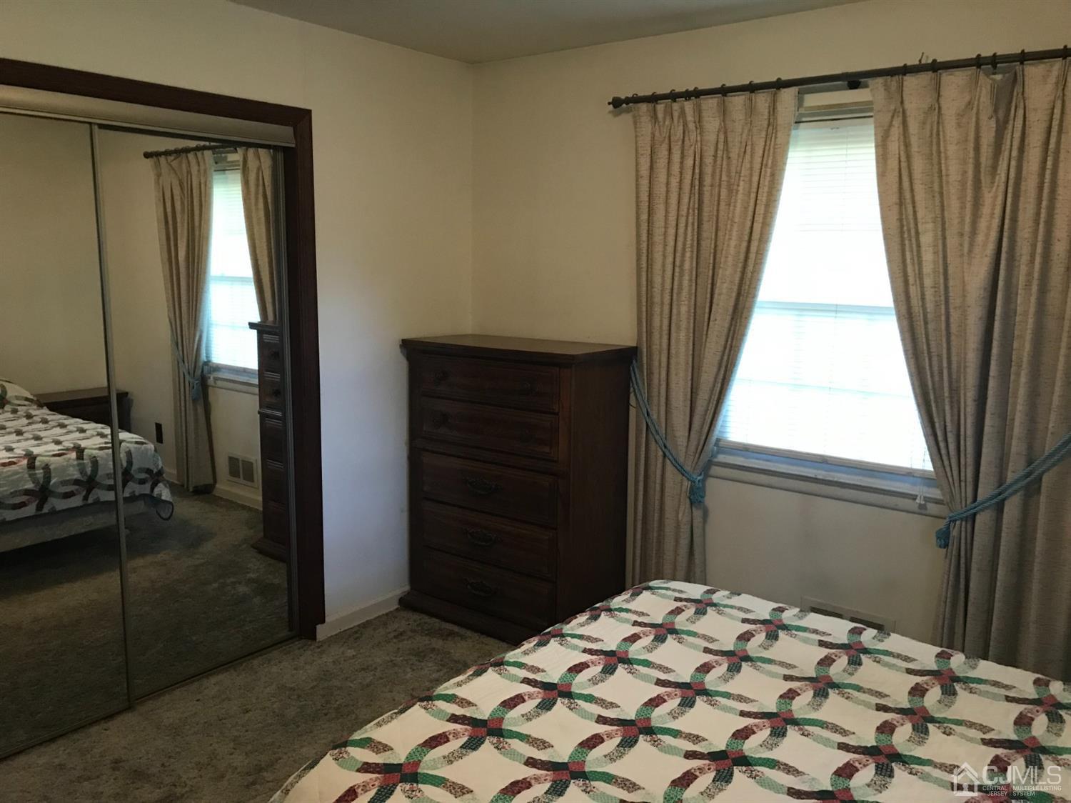 137 Milltown Road East Brunswick, NJ 08816 - Photo 11 of 22 a bedroom with a bed and a window