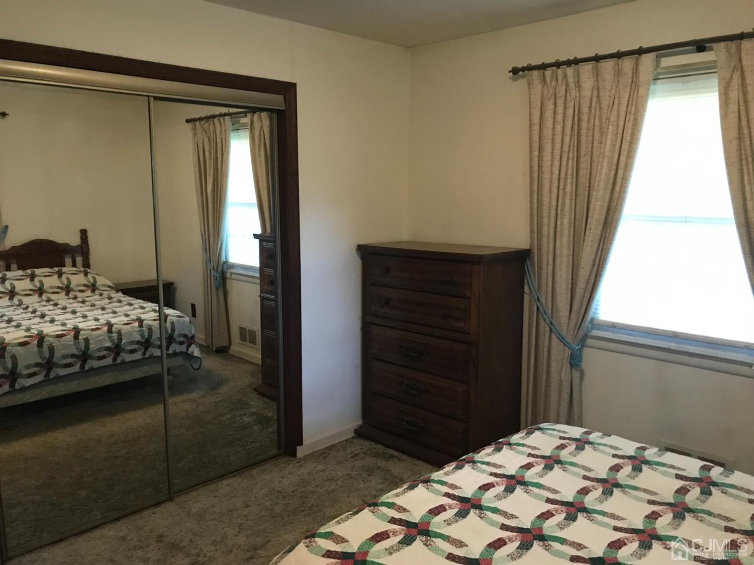 137 Milltown Road East Brunswick, NJ 08816 - Photo 12 of 22 a bedroom with a bed and a window
