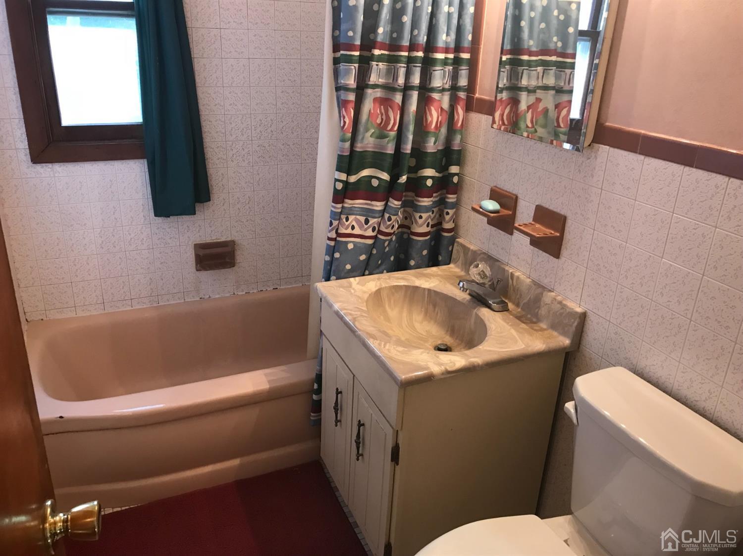 137 Milltown Road East Brunswick, NJ 08816 - Photo 13 of 22 a bathroom with a sink toilet and tub