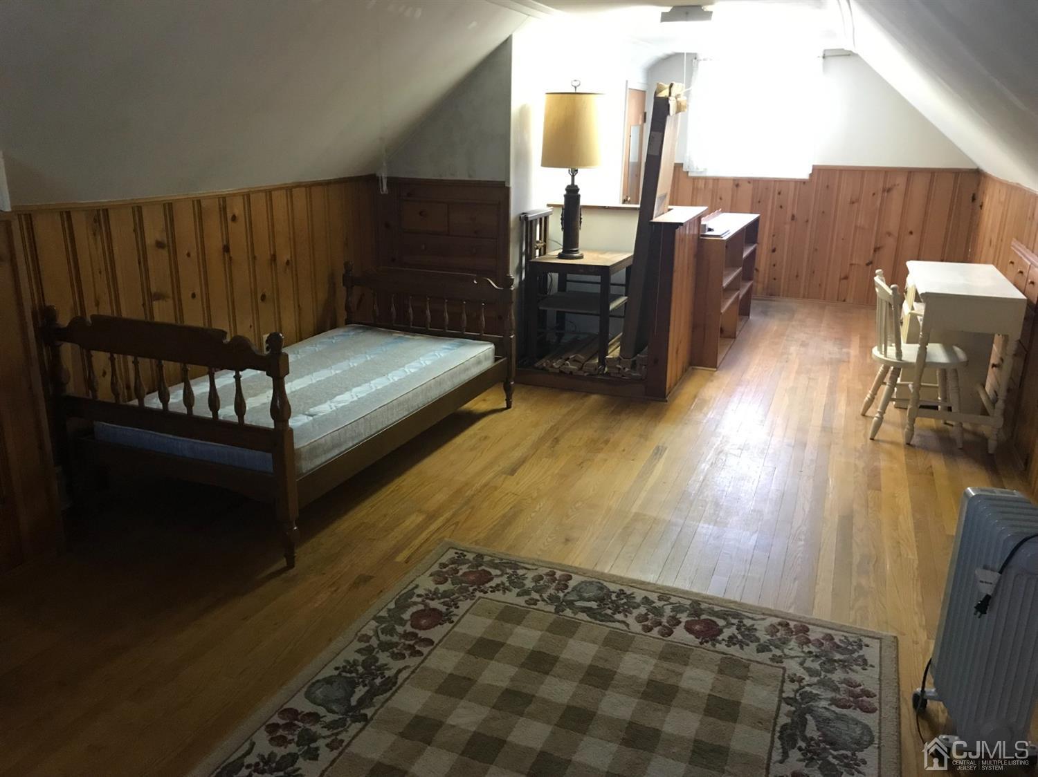137 Milltown Road East Brunswick, NJ 08816 - Photo 15 of 22 a bedroom with furniture and wooden floor