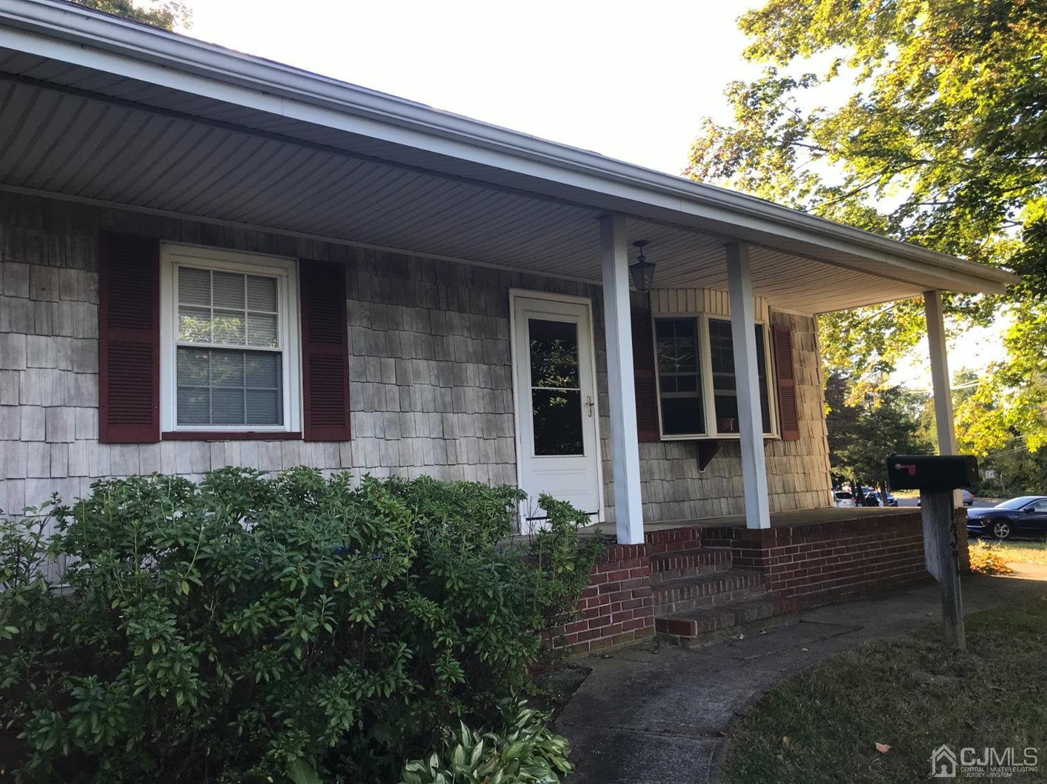 137 Milltown Road East Brunswick, NJ 08816 - Photo 3 of 22 a front view of a house with a garden
