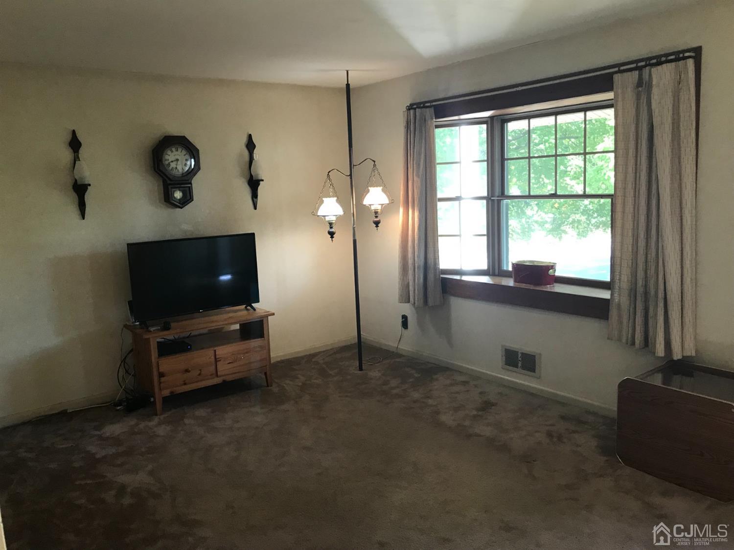 137 Milltown Road East Brunswick, NJ 08816 - Photo 5 of 22 a living room with furniture and a flat screen tv