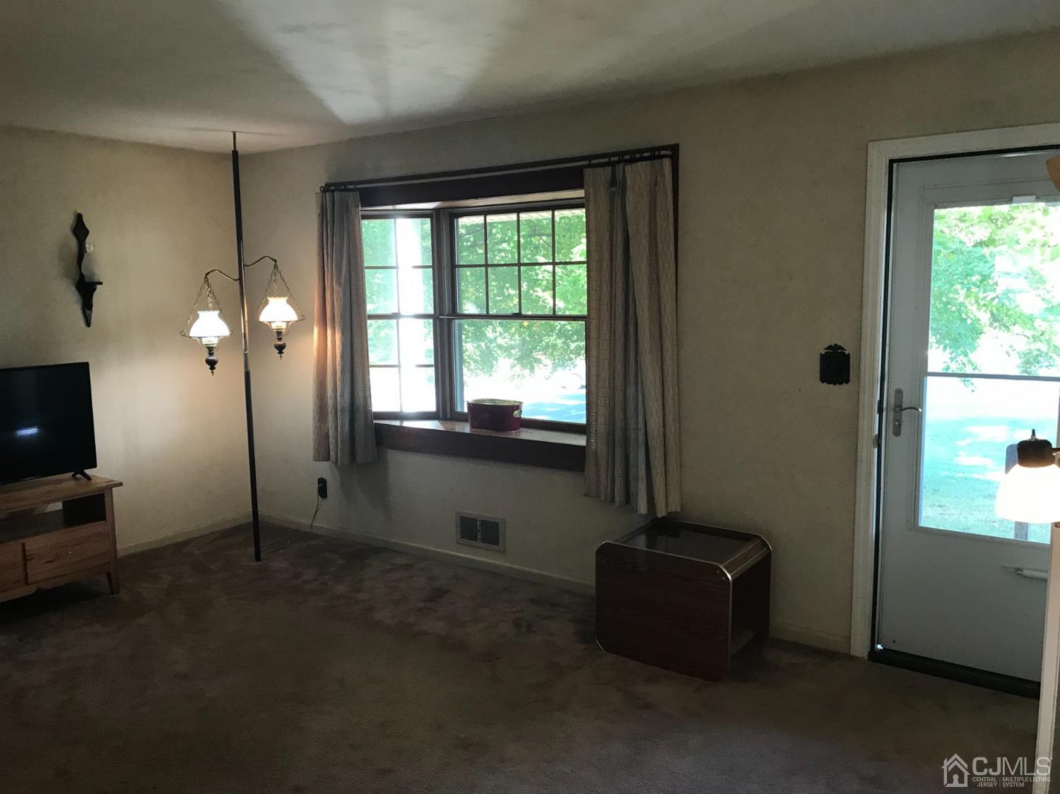 137 Milltown Road East Brunswick, NJ 08816 - Photo 6 of 22 a living room with furniture and a flat screen tv
