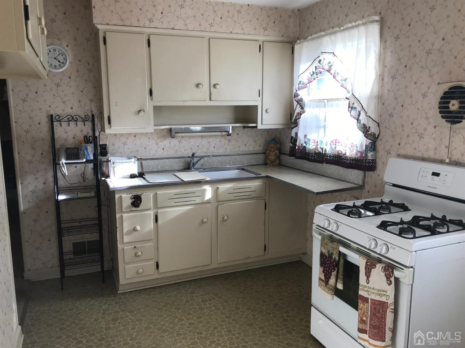 137 Milltown Road East Brunswick, NJ 08816 - Photo 8 of 22 a kitchen with cabinets appliances and a stove