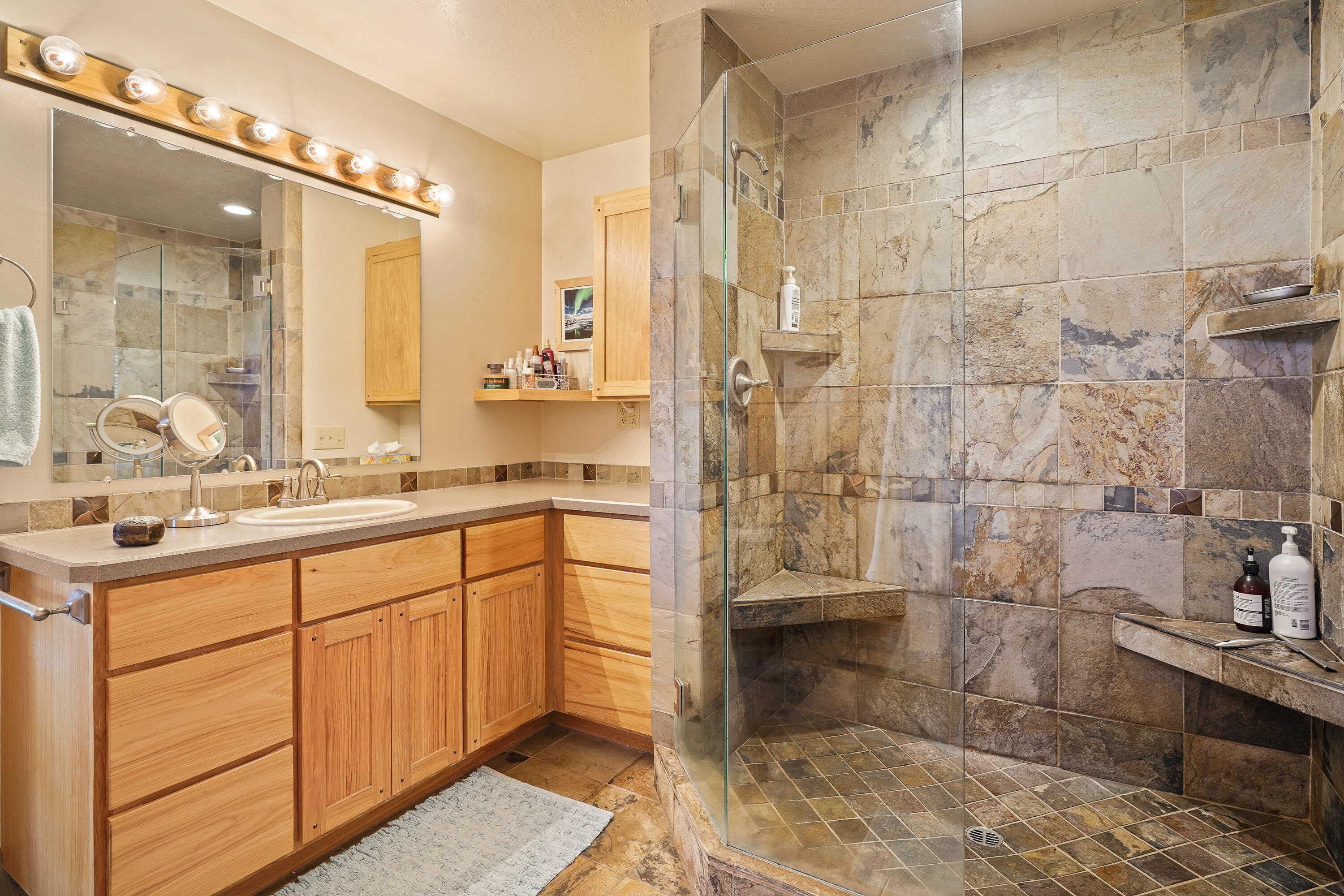 62636 Erickson Road Bend, OR 97701 - Photo 21 of 47 a spacious bathroom with a double vanity sink a mirror and a shower