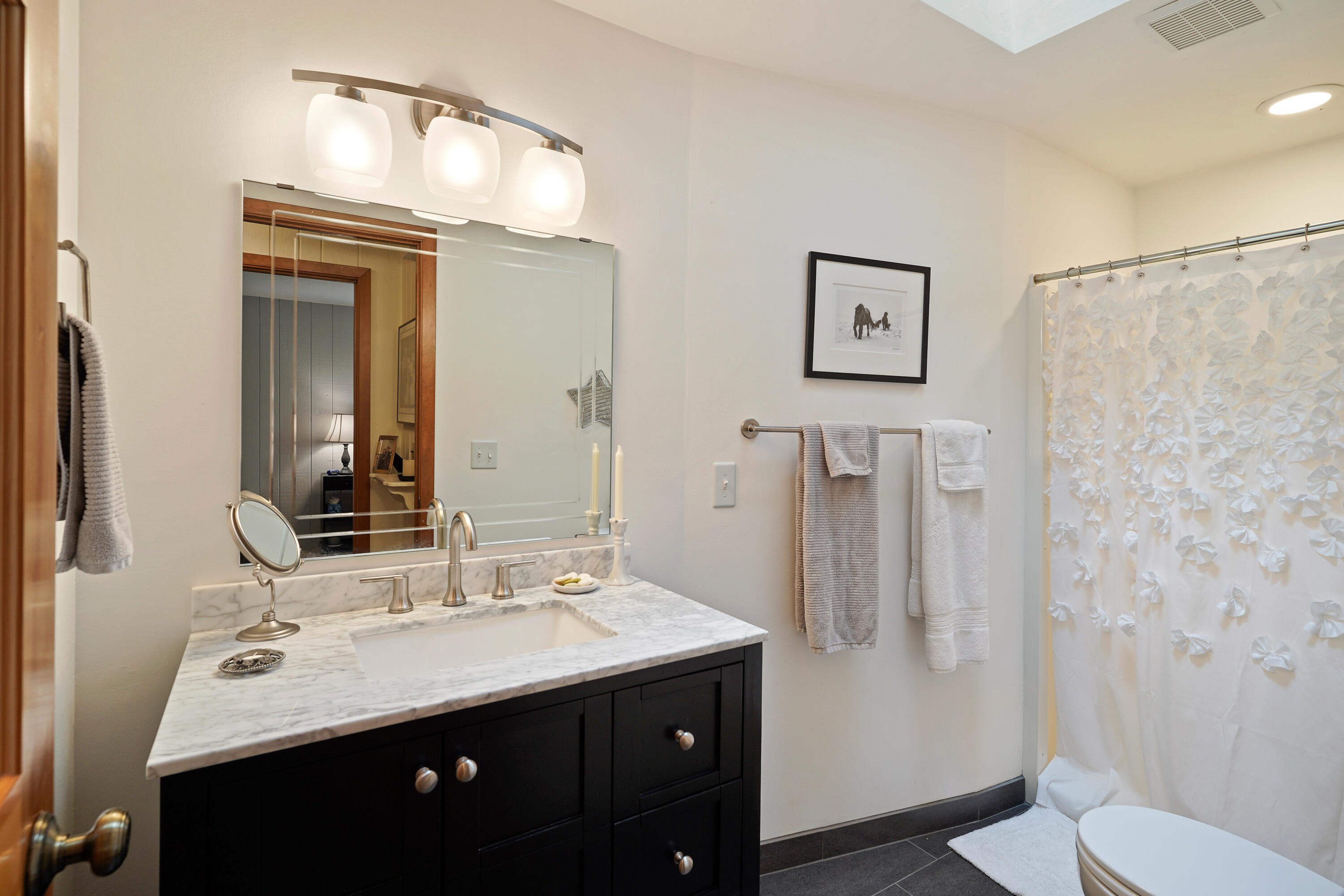 62636 Erickson Road Bend, OR 97701 - Photo 24 of 47 a bathroom with a sink vanity mirror and toilet