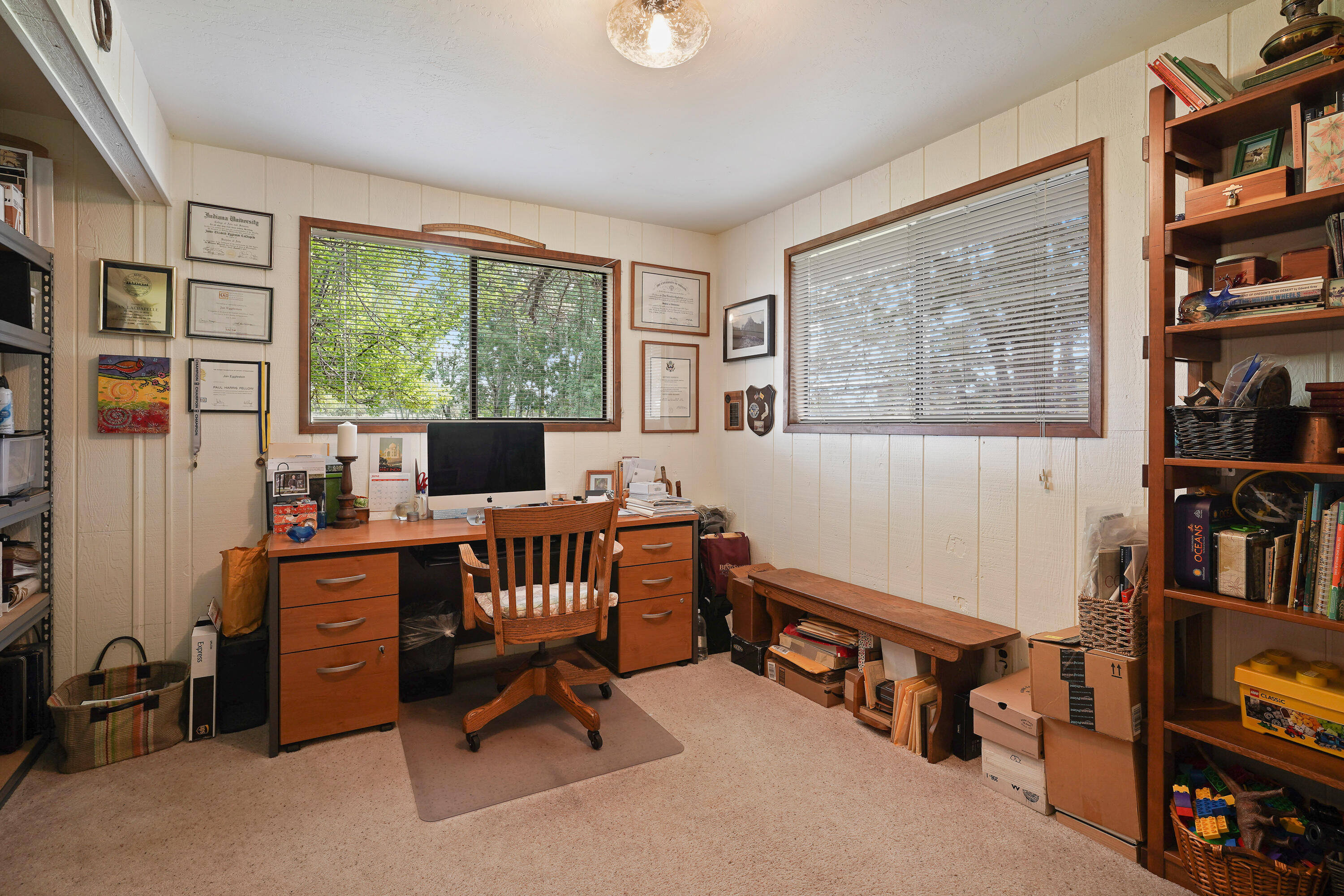 62636 Erickson Road Bend, OR 97701 - Photo 25 of 47 a view of a workspace with furniture and a bookshelf