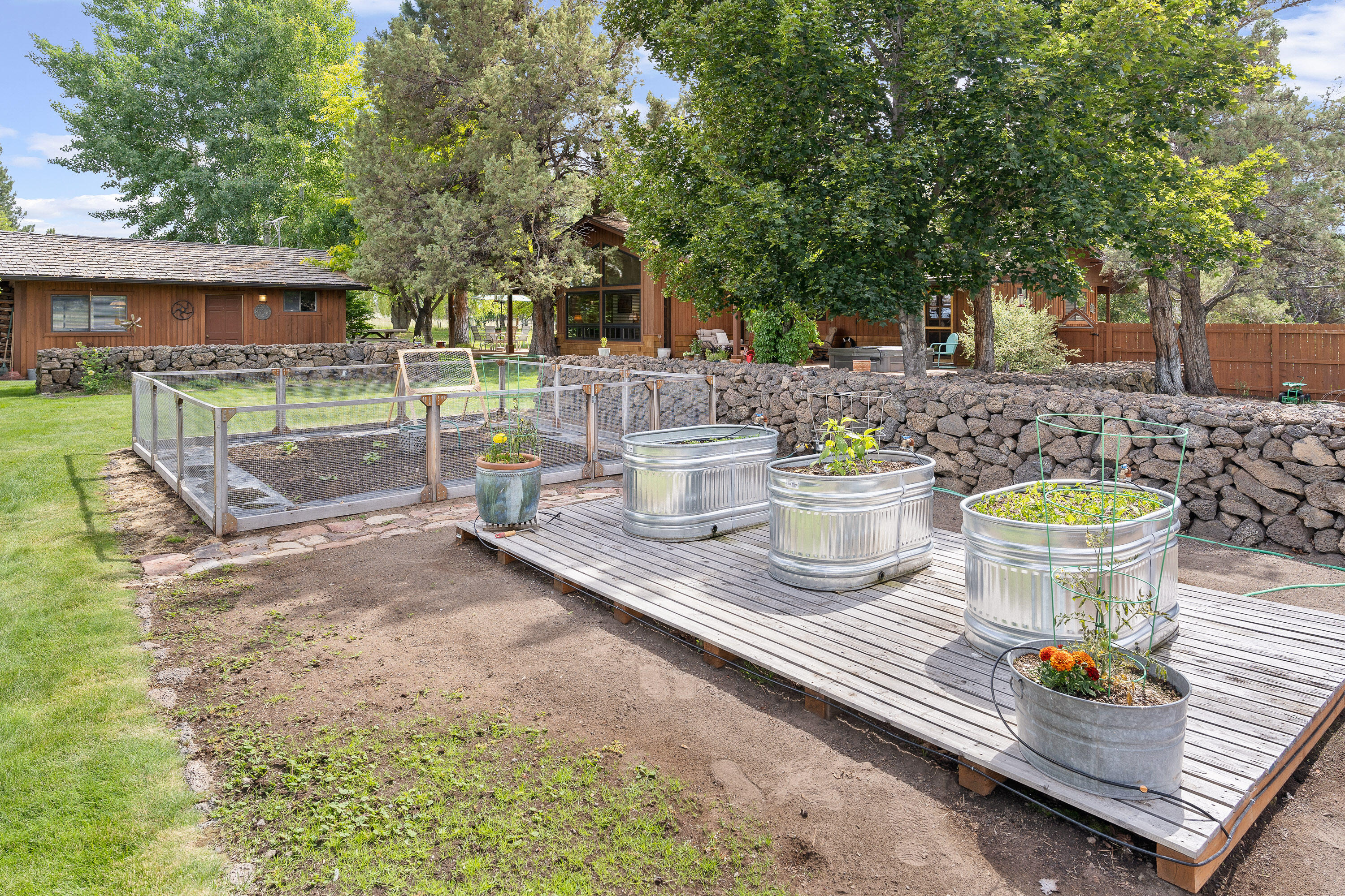 62636 Erickson Road Bend, OR 97701 - Photo 37 of 47 a view of a patio with table and chairs and potted plants