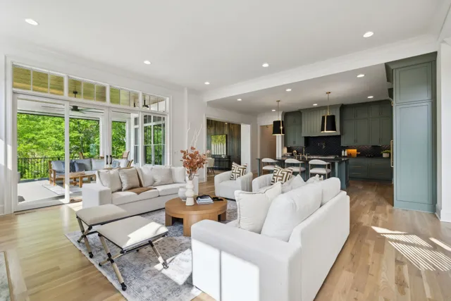 a large kitchen with kitchen island a large counter top space a sink stainless steel appliances and cabinets