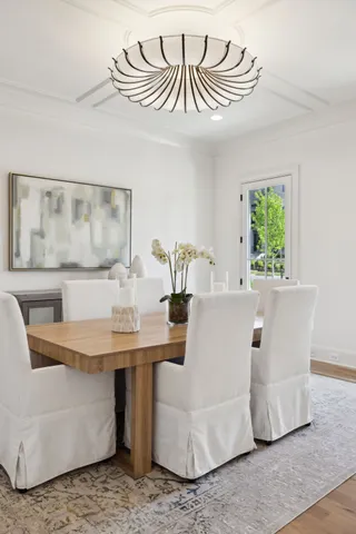 a living room with fireplace furniture and a large window