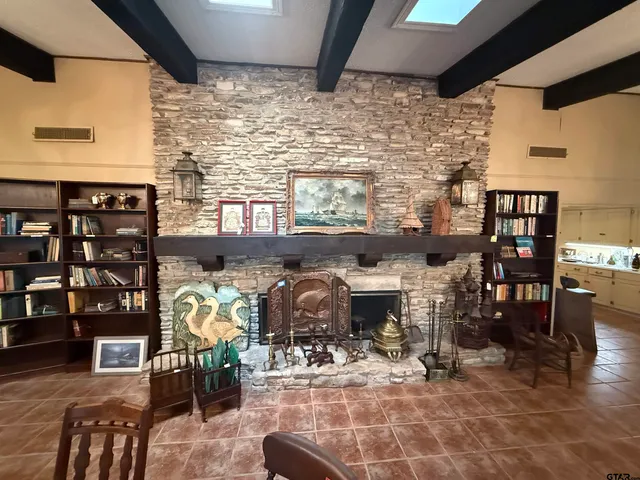 a view of a livingroom with furniture and a window