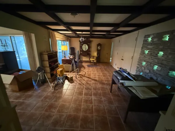 a room with lots of furniture and a chandelier