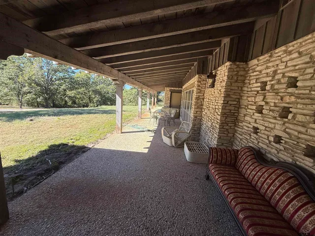 a view of an empty room and floor to ceiling window