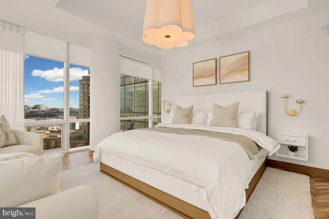 a bedroom with a large bed and a large window