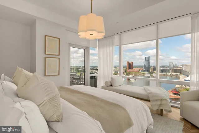 a large bedroom with a large bed and a large window