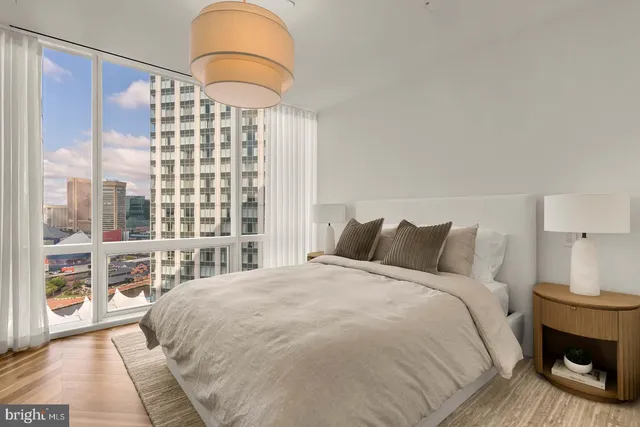 a bedroom with a large bed and a large window