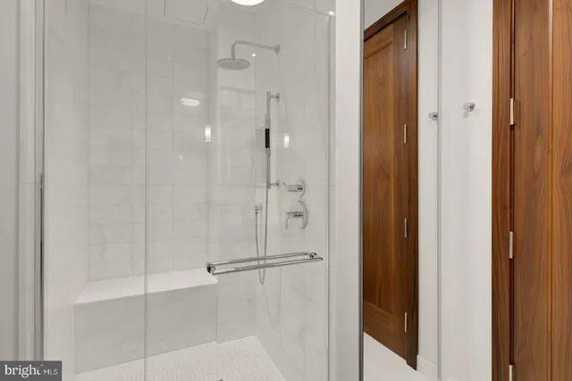 a bathroom with a glass shower door