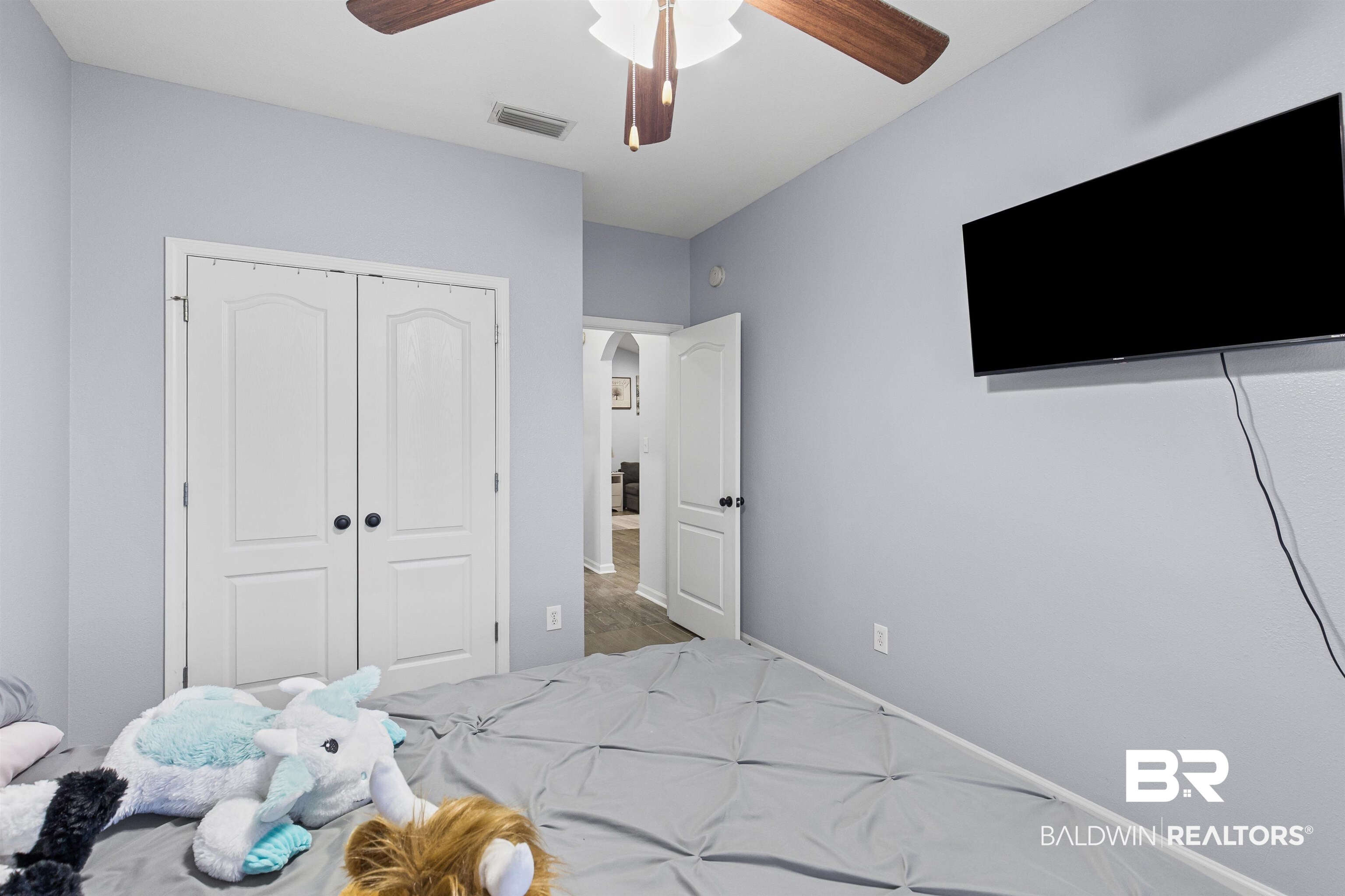 4107 Nottingham Drive Semmes, AL 36575 - Photo 15 of 23 Bedroom with a ceiling fan, a closet, arched walkways, and carpet flooring