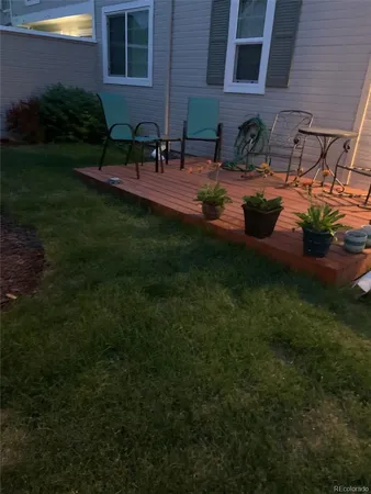 a view of a backyard with plants and chairs