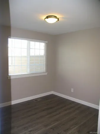 a view of a room with wooden floor and window