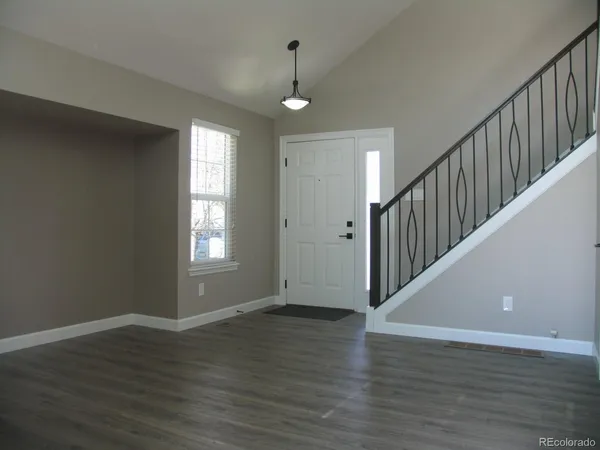 a view of wooden floor and windows in a room