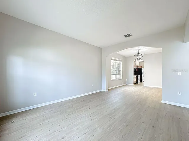 a kitchen with stainless steel appliances granite countertop a stove top oven a refrigerator and a microwave