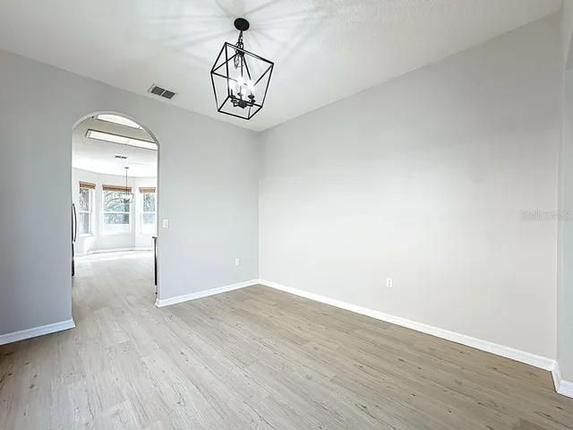 a kitchen with stainless steel appliances a sink a stove a microwave a refrigerator and cabinets