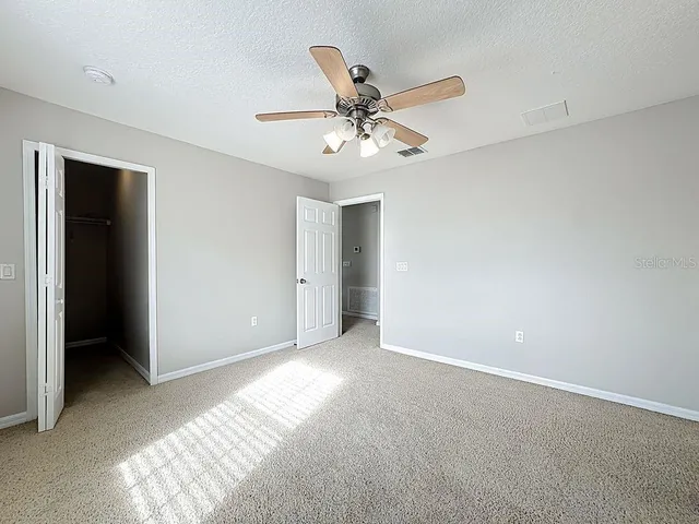 a bathroom with a tub sink shower and mirror