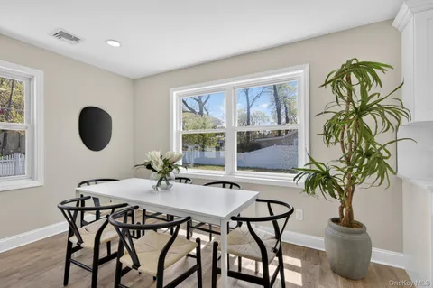 a view of a dining room with furniture window and outside view
