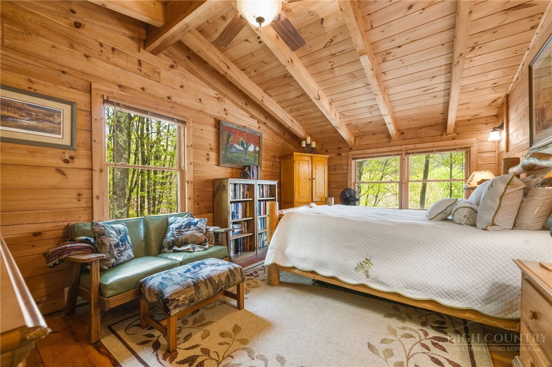 259 Greenbriar Road Beech Mountain, NC 28604 - Photo 22 of 41 a bed room with a bed and a chair