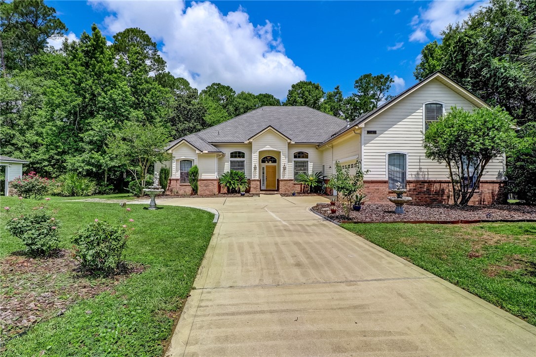96411 Blackrock Road Yulee, FL 32097 - Photo 1 of 34 a front view of a house with yard patio and green space