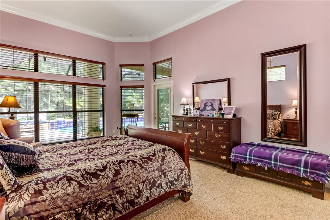 96411 Blackrock Road Yulee, FL 32097 - Photo 16 of 34 a bedroom with a bed and glass windows