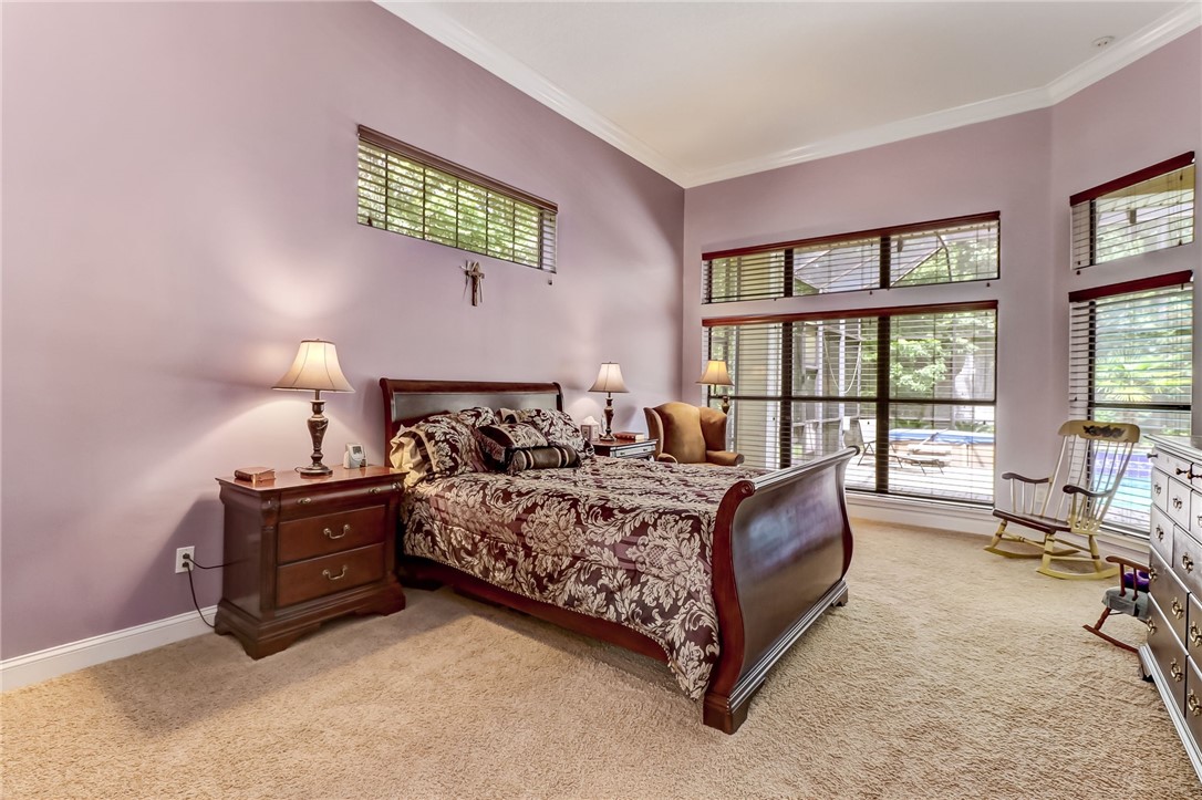 96411 Blackrock Road Yulee, FL 32097 - Photo 17 of 34 a spacious bedroom with a bed and a couch