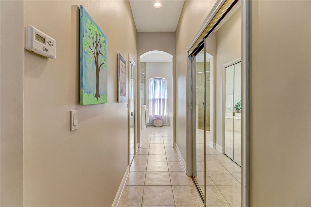 96411 Blackrock Road Yulee, FL 32097 - Photo 18 of 34 a view of a hallway with wooden floor and glass door