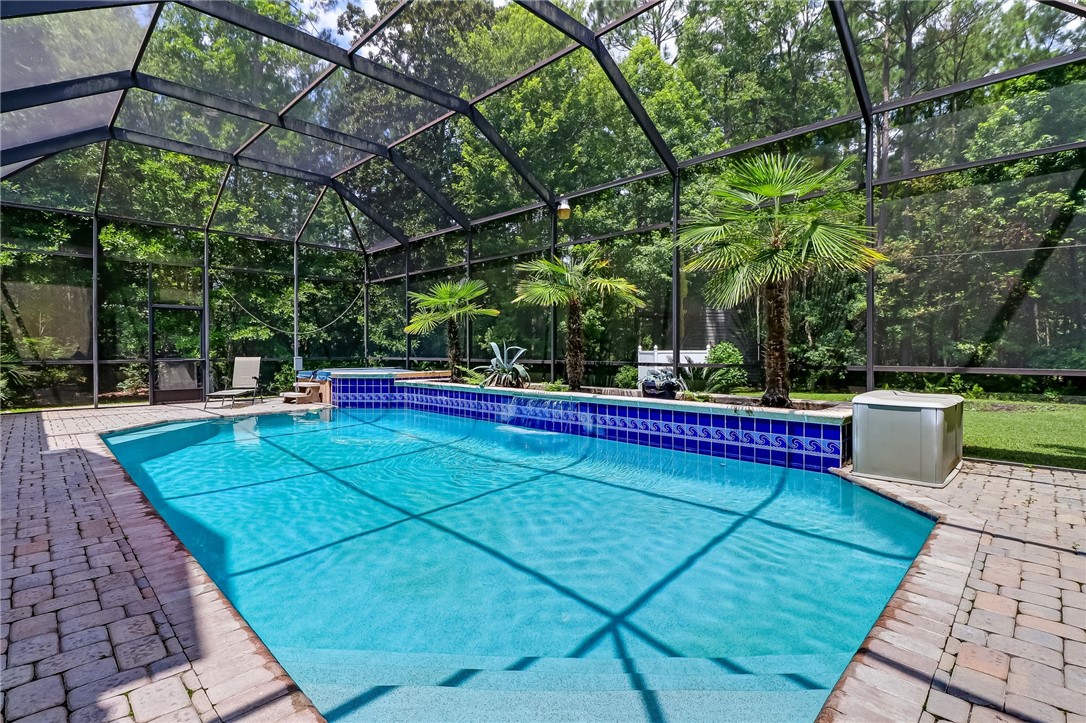 96411 Blackrock Road Yulee, FL 32097 - Photo 2 of 34 a view of a swimming pool with a patio