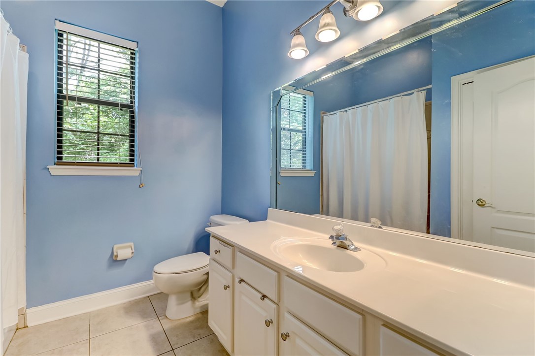 96411 Blackrock Road Yulee, FL 32097 - Photo 22 of 34 a bathroom with a sink a toilet and mirror