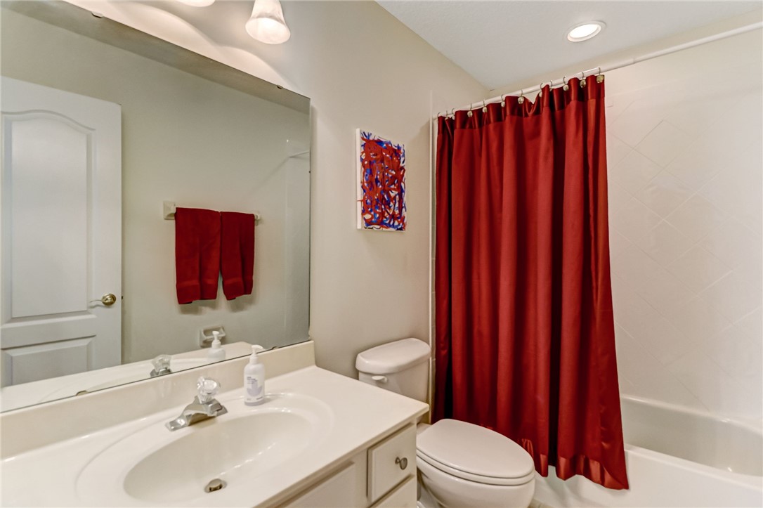 96411 Blackrock Road Yulee, FL 32097 - Photo 29 of 34 a bathroom with a sink a toilet and shower curtain