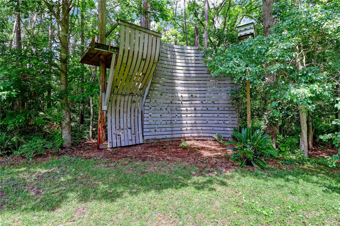 96411 Blackrock Road Yulee, FL 32097 - Photo 32 of 34 a view of a backyard with plants and large trees