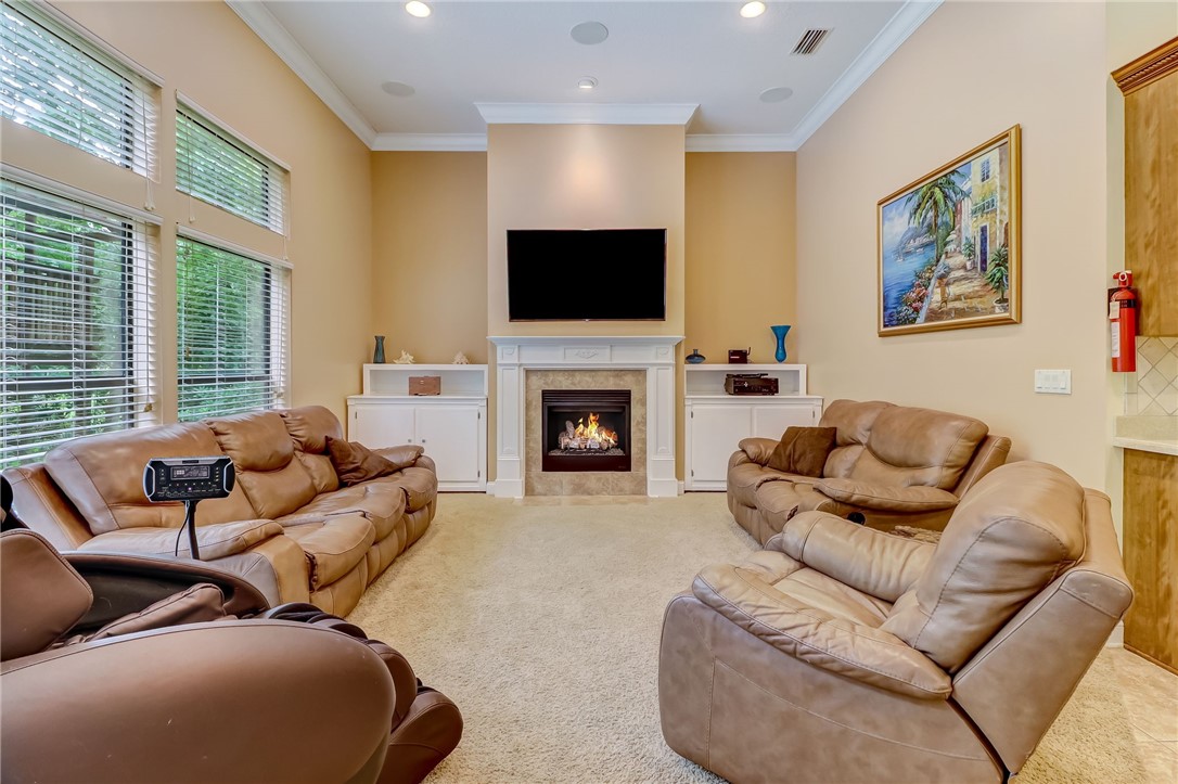96411 Blackrock Road Yulee, FL 32097 - Photo 9 of 34 a living room with furniture flat screen tv and a fireplace