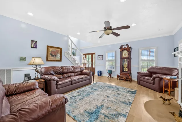 a room with stainless steel appliances furniture and a kitchen view